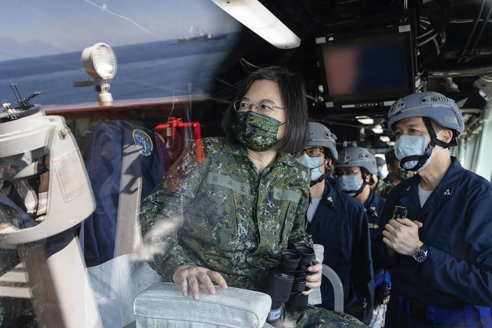 FILE - In this photo released by the Taiwan Presidential Office, Taiwan's President Tsai Ing-wen is seen through glass onboard a navy ship during inspection of Taiwan's annual Han Kuang exercises in Taiwan on Tuesday, July 26, 2022. Tsai said Tuesday, Sept. 6, 2022, that China is conducting “cognitive warfare” by spreading misinformation in addition to its regular incursions into nearby waters and airspace intended at intimidating the self-governing island. (Shioro Lee/Taiwan Presidential Office via AP, File)